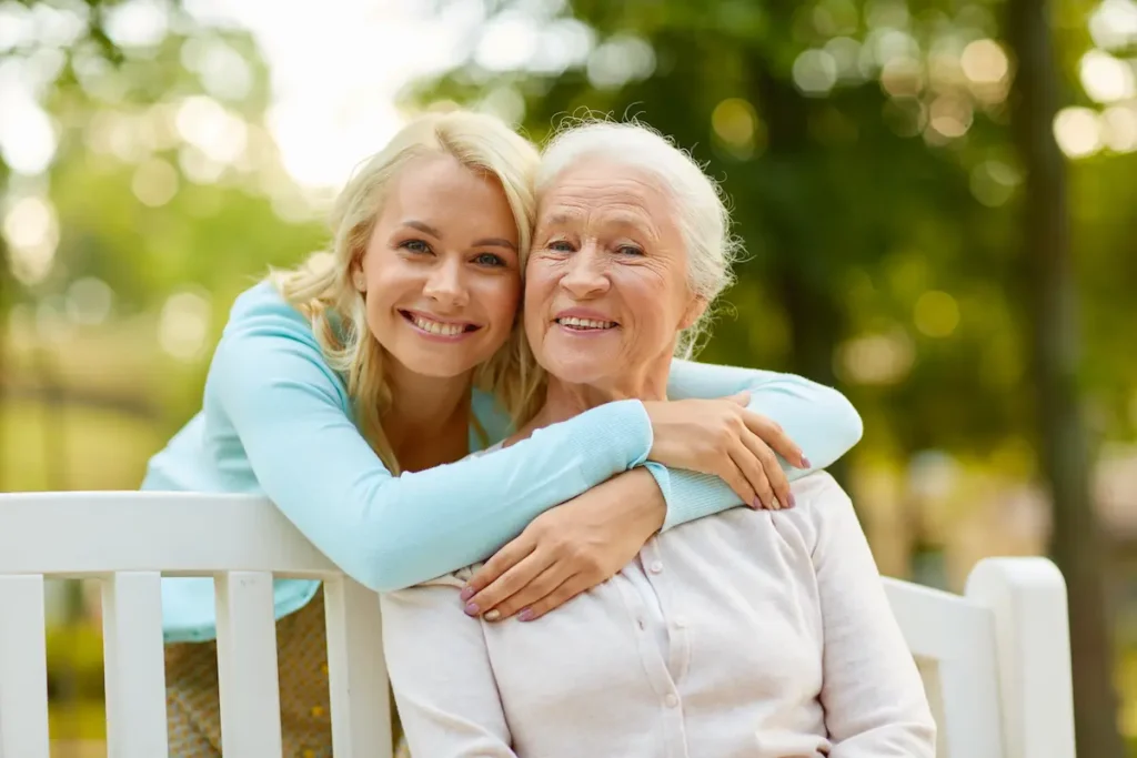 The Oaks of Garden Ridge | Senior woman and daughter looking at sitting on a park bench