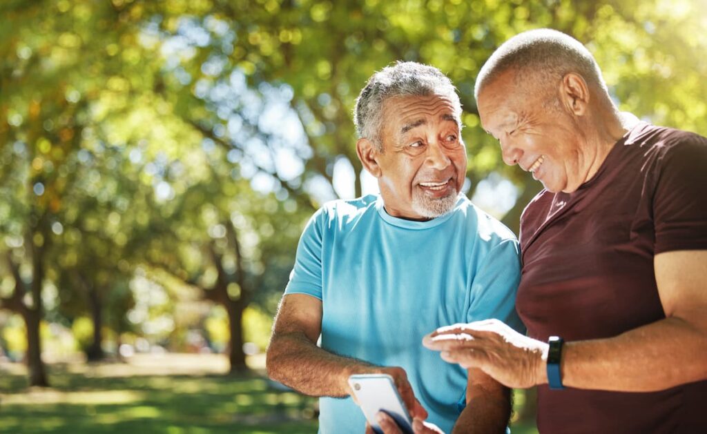 The Oaks of Garden Ridge | Senior friends looking at a phone after a workout