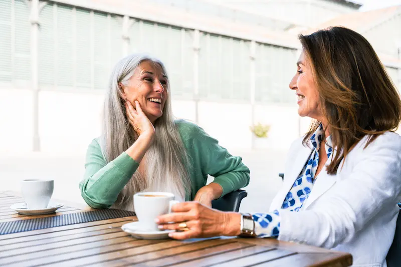 The Oaks of Garden Ridge | Senior friends talking over coffee