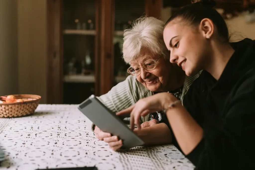 The Oaks of Garden Ridge | Senior woman and granddaughter looking at a tablet